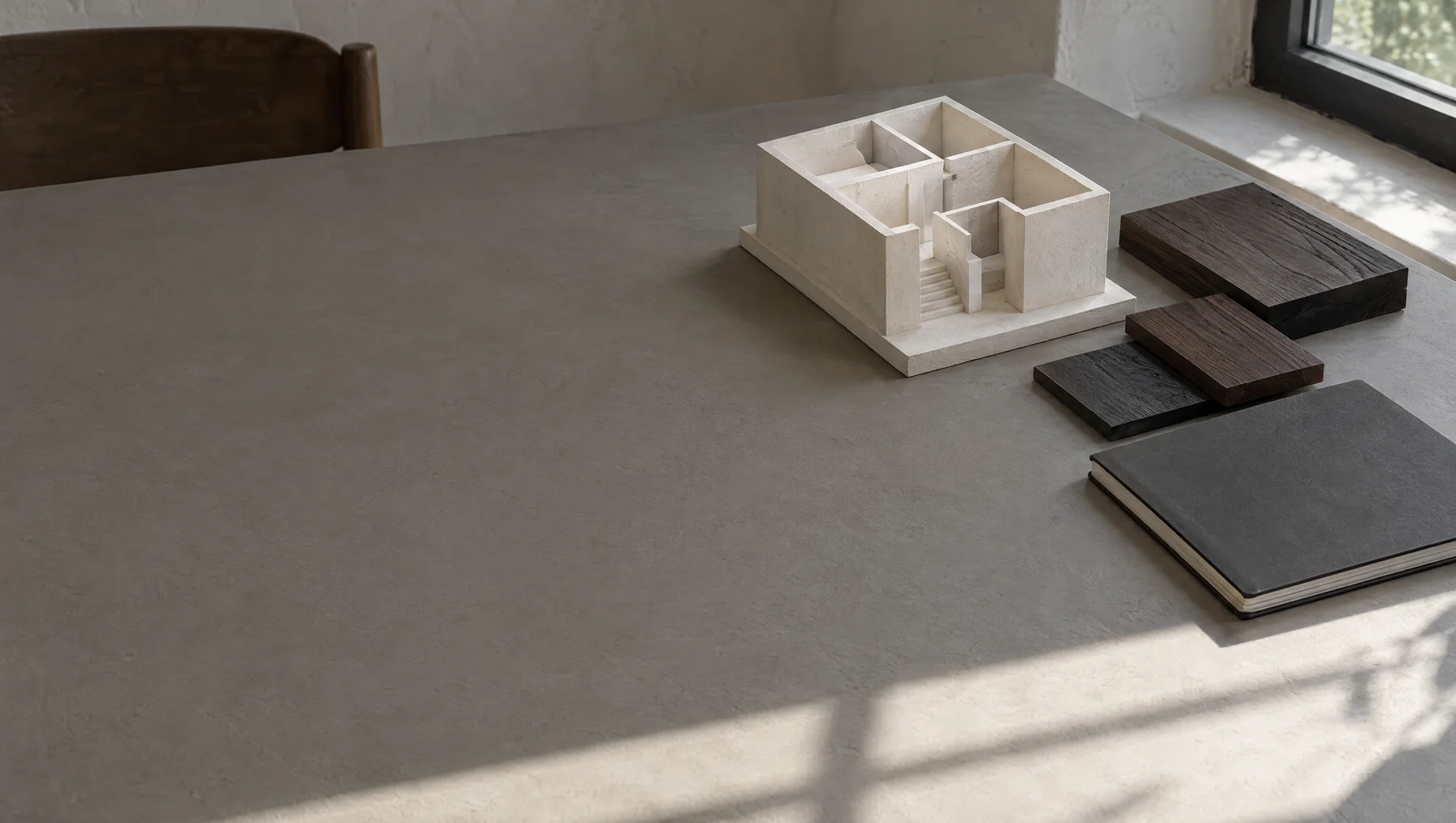 Room models and timber samples on the studio worktable